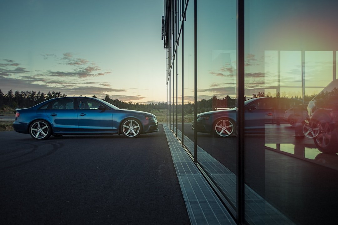 Blue Audi A4 Quattro Saloon Scene with Swedish architecture at dealership